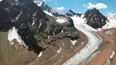 High rocky mountains covered with ice in places.の写真素材