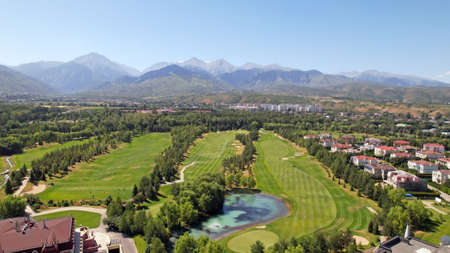 Golf course with a view of the high mountains.の写真素材