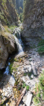 A mountain waterfall in a rocky gorge.の写真素材