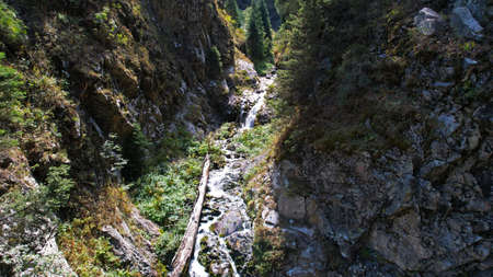 A mountain waterfall in a rocky gorge.の写真素材