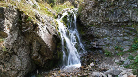 A mountain waterfall in a rocky gorge.の写真素材