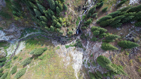 A mountain waterfall in a rocky gorge.の写真素材