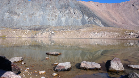 Transparent mountain lake surrounded by high cliffの写真素材
