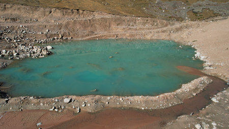 A mountain artificial lake with blue water and dam