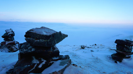 An ocean of clouds in the snowy mountains at dawnの写真素材