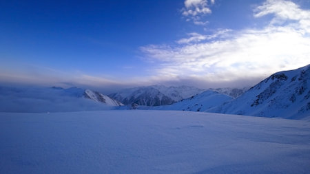 Ocean of clouds in snowy mountains at dawnの写真素材