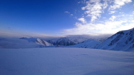 Ocean of clouds in snowy mountains at dawnの写真素材