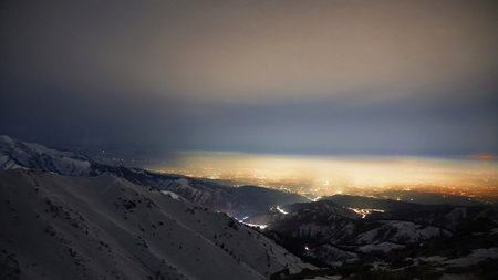 View of the night city from the snowy mountainsの写真素材