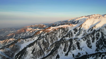 Epic red-orange sunset in high snowy mountainsの写真素材