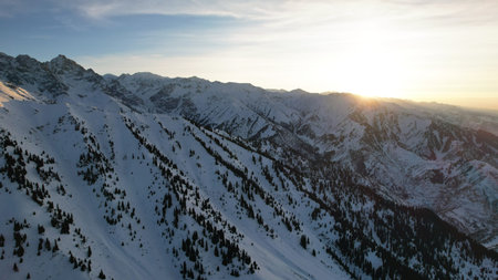 Epic red-orange sunset in high snowy mountains