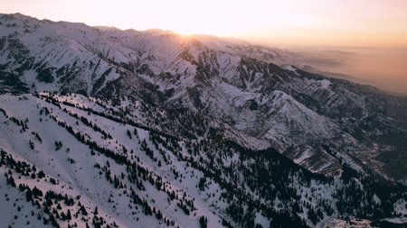 Epic red-orange sunset in high snowy mountains