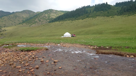 White yurt among green fields and riversの写真素材