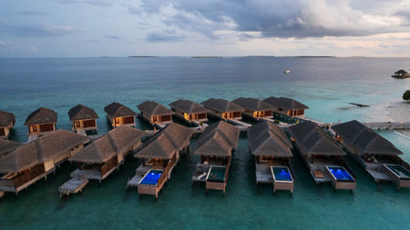 Top view of the sunset over an island in the oceanの写真素材