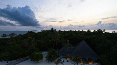 Top view of the sunset over an island in the oceanの写真素材