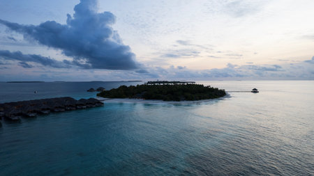 Top view of the sunset over an island in the oceanの写真素材
