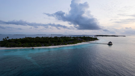 Top view of the sunset over an island in the oceanの写真素材
