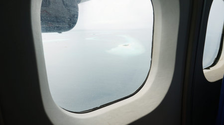 Tropical islands seen from airplane window flying over ocean