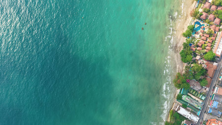 Catamaran sailing near tropical beach resort in thailand, aerial viewの写真素材