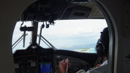 Pilot flying over tropical islands in maldivesの写真素材