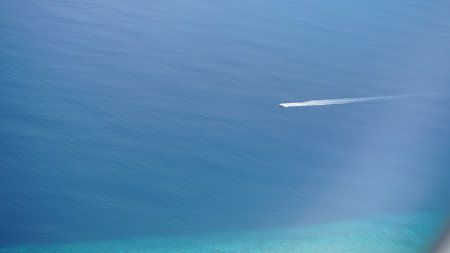 Speedboat moving on deep blue sea leaving white trailの写真素材