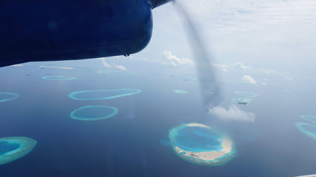 Flying over the maldives islands in a seaplane with a breathtaking view