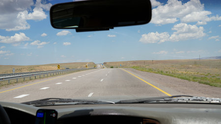 Driving on a highway under a cloudy sky, navigating the open roadの写真素材