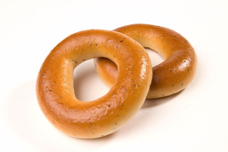 Two appetizing bagels at the table, isolatedの写真素材