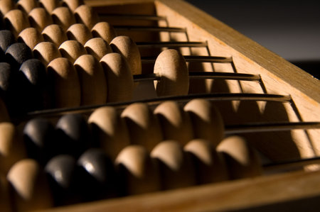 Obsolete wooden abacus, black backgroundの写真素材
