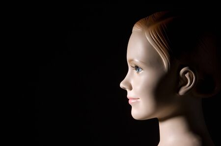 Mannequin tailors, plastic figure of girl on dark backgroundの写真素材