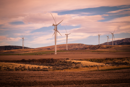 A wind turbine canvases the countryside, as cropland does double-duty producing green energy for Idaho.の写真素材