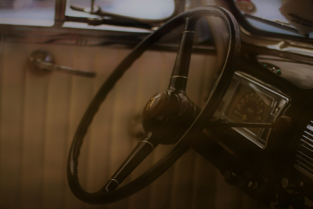A steering wheel inside a vintage car.の写真素材