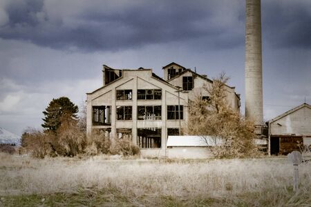 The Franklin County Sugar Factory near Preston, Idaho sits abandoned against a dark and cloudy sky.の写真素材