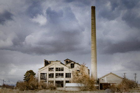 The Franklin County Sugar Factory near Preston, Idaho sits abandoned against a dark and cloudy sky.
