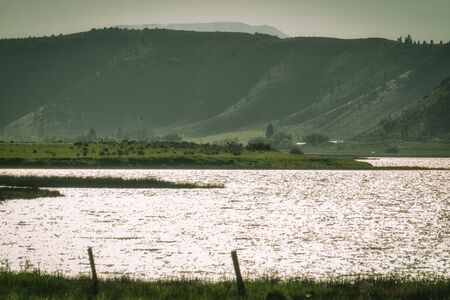 A windy evening creates shimmering waves of sunset on the Alexander Reservoir in Soda Springs, Idaho.の写真素材