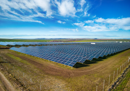 Solar panel produces green, environmentaly friendly energy from the setting sun. Aerial view from drone. Landscape picture of a solar plant that is located inside a valleyの写真素材
