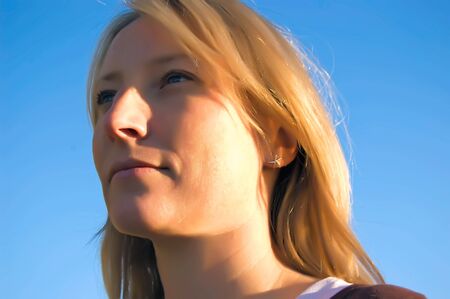 A pretty woman with blue eyes looks skywardの写真素材