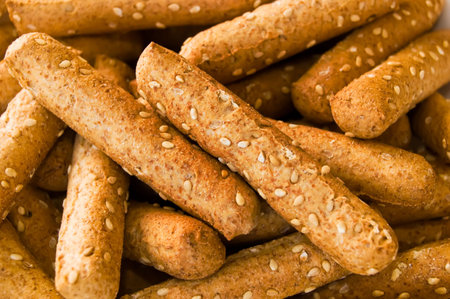 A close up shot of sesame seed breadsticksの写真素材