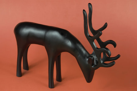 A reindeer figurine on a red backgroundの写真素材