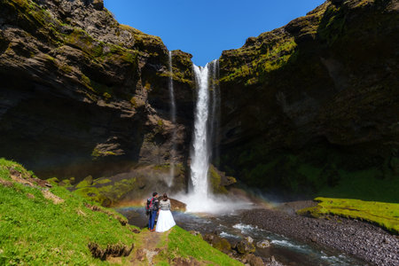 Romantic Elopement in Front of Majestic Icelandic Waterfallの写真素材