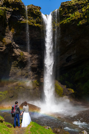 Romantic Elopement in Front of Majestic Icelandic Waterfallの写真素材