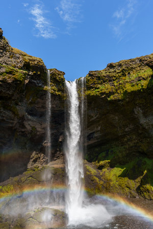 Stunning Rainbow Arcs Over Majestic Icelandic Waterfallの写真素材