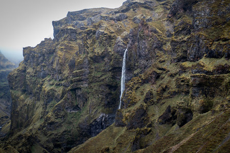 Waterfall in the mountains of Iceland on a foggy day.の写真素材
