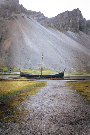 A reconstructed Viking village set against the dramatic Vestrahorn Mountain at Stokksnes, East Iceland. This cinematic location showcases Iceland's Viking heritage and breathtaking natural beautyの写真素材