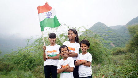 Group of happy Indian wearing traditional white dress holding indian flag celebrating Independence...