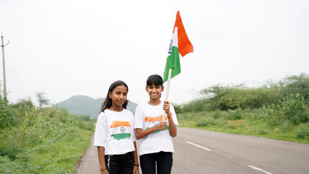 Indian child celebrating Independence or Republic day, Cute little Indian child holding, waving or...