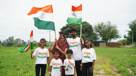 Group of happy Indian wearing traditional white dress holding indian flag celebrating Independence...