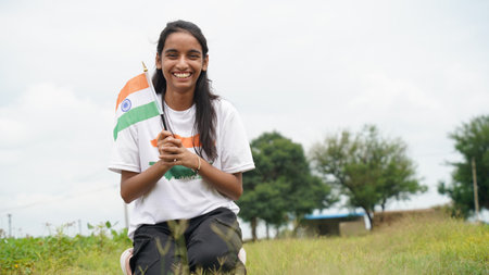 Indian child celebrating Independence or Republic day, Cute little Indian child holding, waving or running with Tricolour flag. Har Ghar Tirangaの写真素材