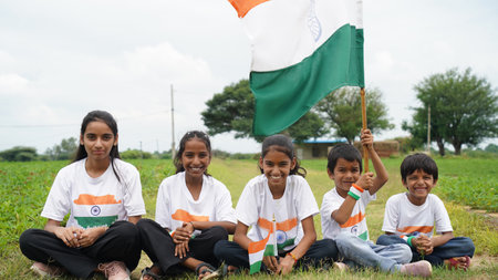 Group of  student or kids wearing indian tricolor Tshirt, face painted with triclolor and saluting. celebrating Independence or Republic day. Har Ghar Tirangaの写真素材