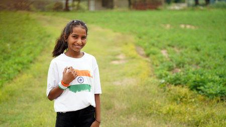 Indian child celebrating Independence or Republic day, Cute little Indian child holding, waving or...