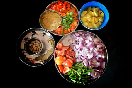 Different vegetables for cooking healthy vegetarian vegan diet food. Cutting vegetable on wooden board on kitchenの写真素材